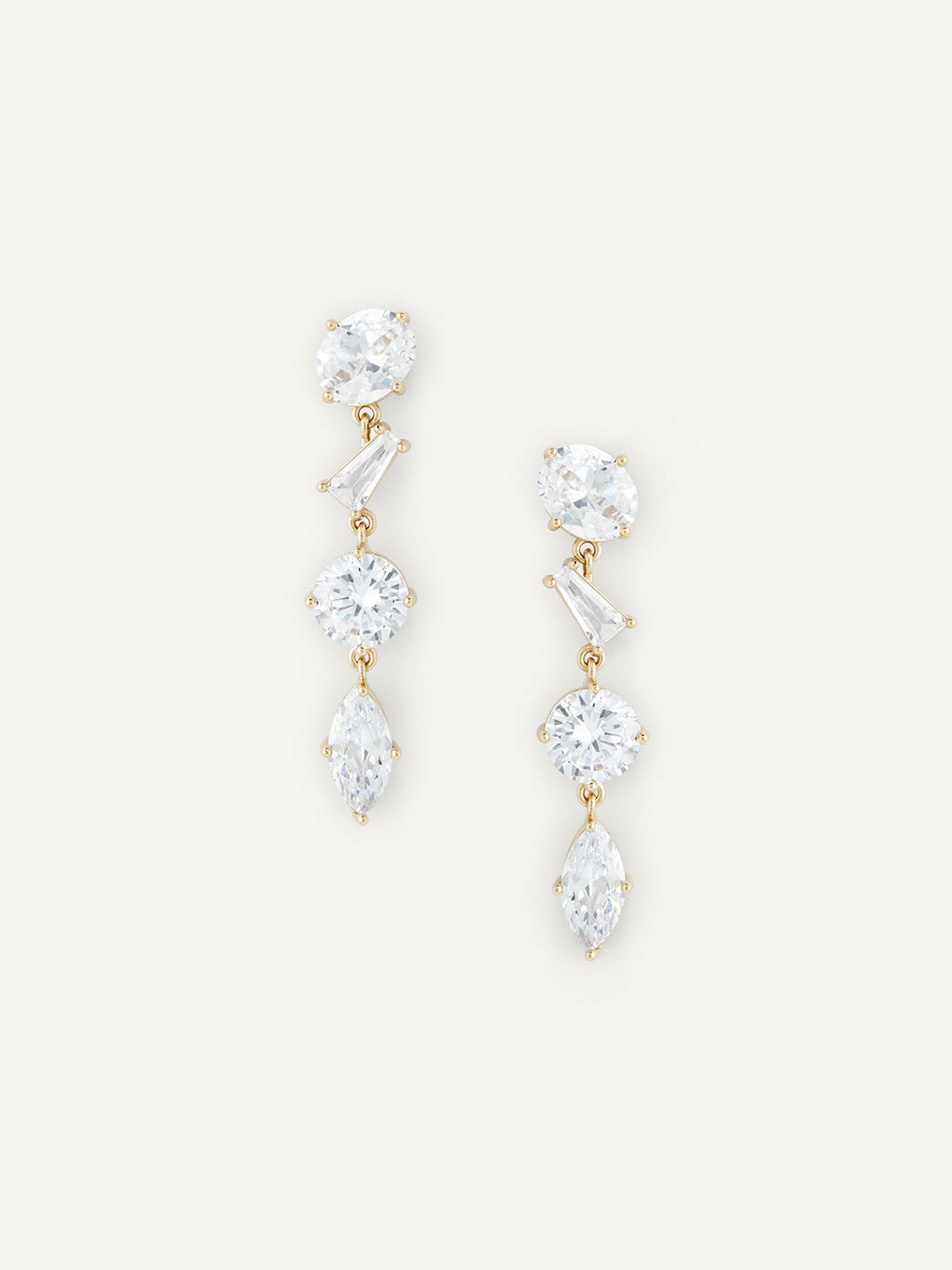 Pair of gold and crystal drop earrings on a white background