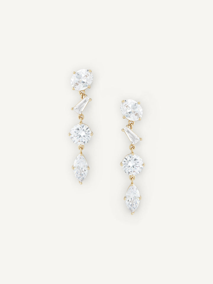 Pair of gold and crystal drop earrings on a white background