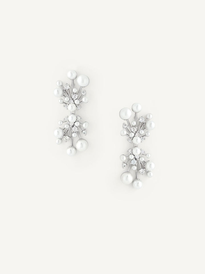 Pair of silver earrings with pearls on a white background