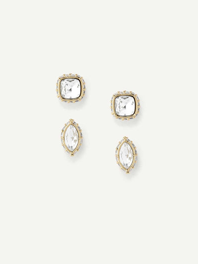 Set of gold and crystal stud earrings on a white background