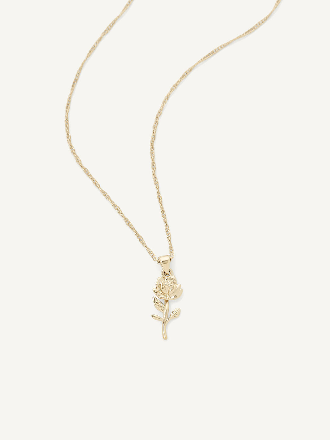 Gold necklace with a rose pendant on a white background