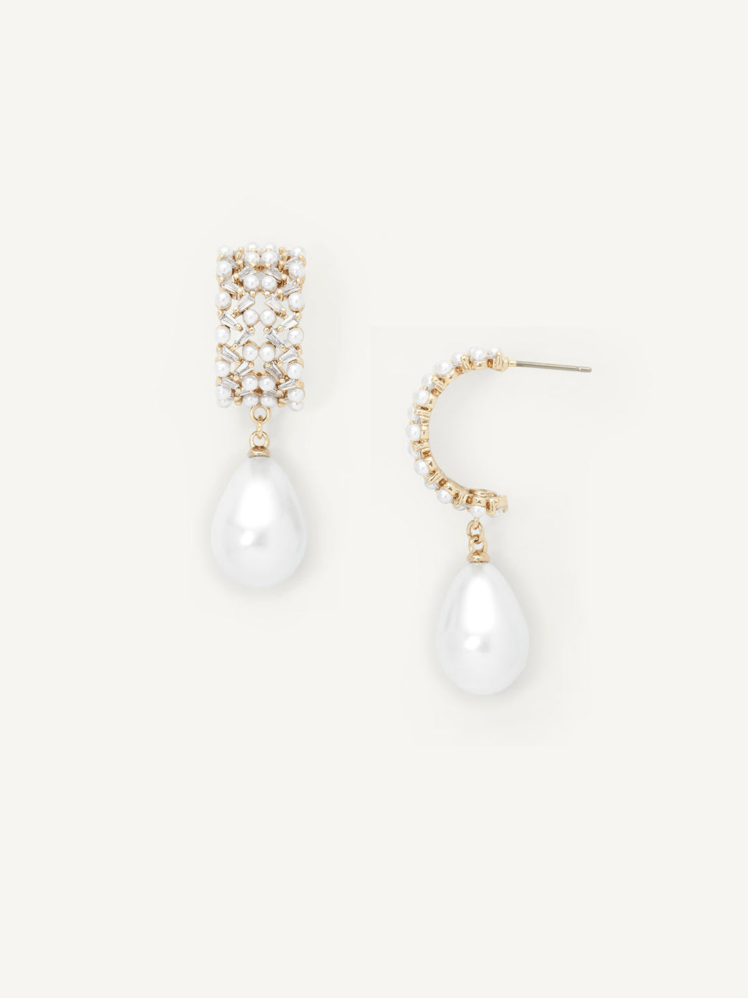 Pair of pearl drop earrings with gold accents on a white background