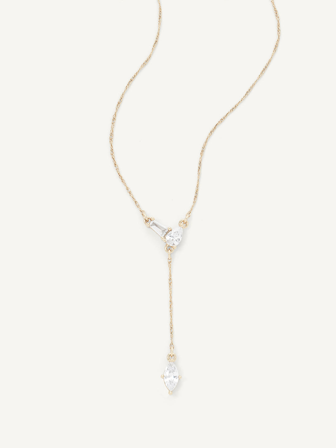 Gold necklace with a teardrop-shaped pendant on a white background