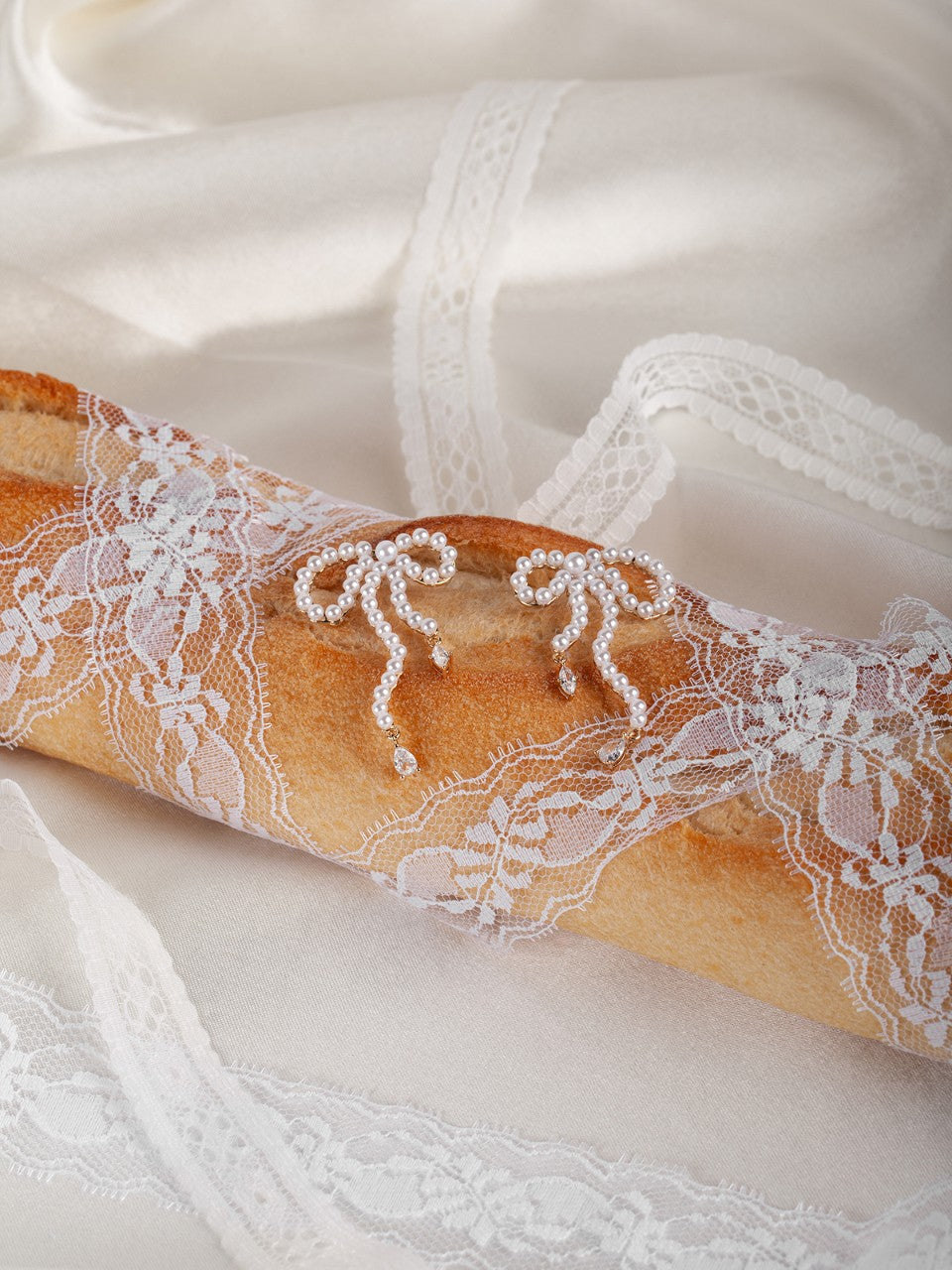 Close-up of a lace-trimmed baguette on a white background