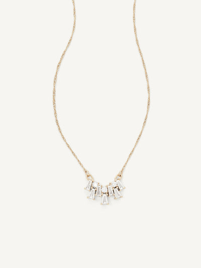 Gold necklace with small gems on a white background