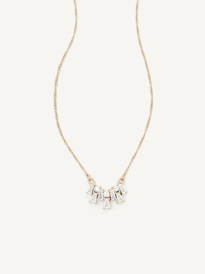 Gold necklace with small gems on a white background